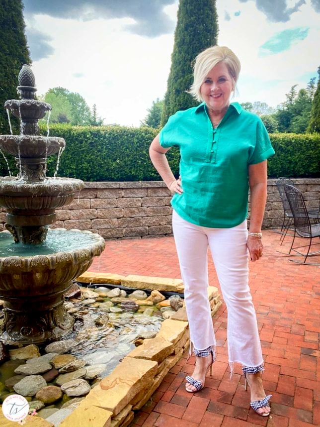Fashion Blogger 50 Is Not Old is wearing a jade linen pullover shirt with white crop jeans and navy and white gingham heels