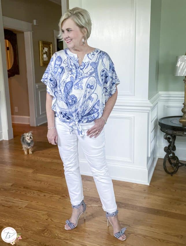 Fashion Blogger 50 Is Not Old is wearing a navy and white paisley tie top with white jeans and navy and white gingham heels