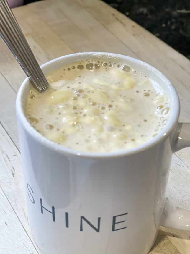 Fashion Blogger 50 Is Not Old is showing clumps from collagen that she put in her morning coffee