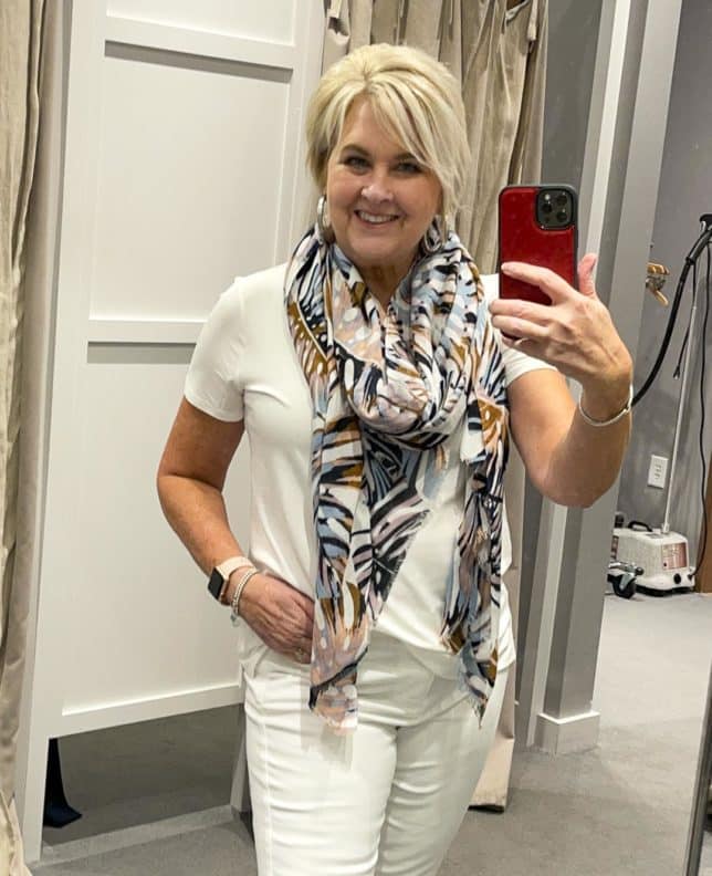 Fashion Blogger 50 Is Not Old is doing a J.Jill try on with a white short sleeve tee shirt, and printed scarf, and white jeans