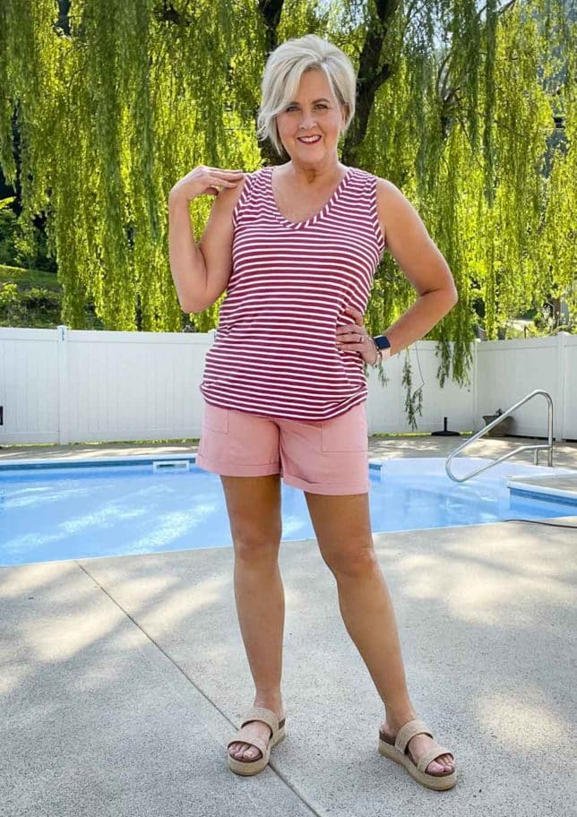 Fashion Blogger 50 Is Not Old is wearing a casual style striped t-shirt and pink twill shorts with platform sandals