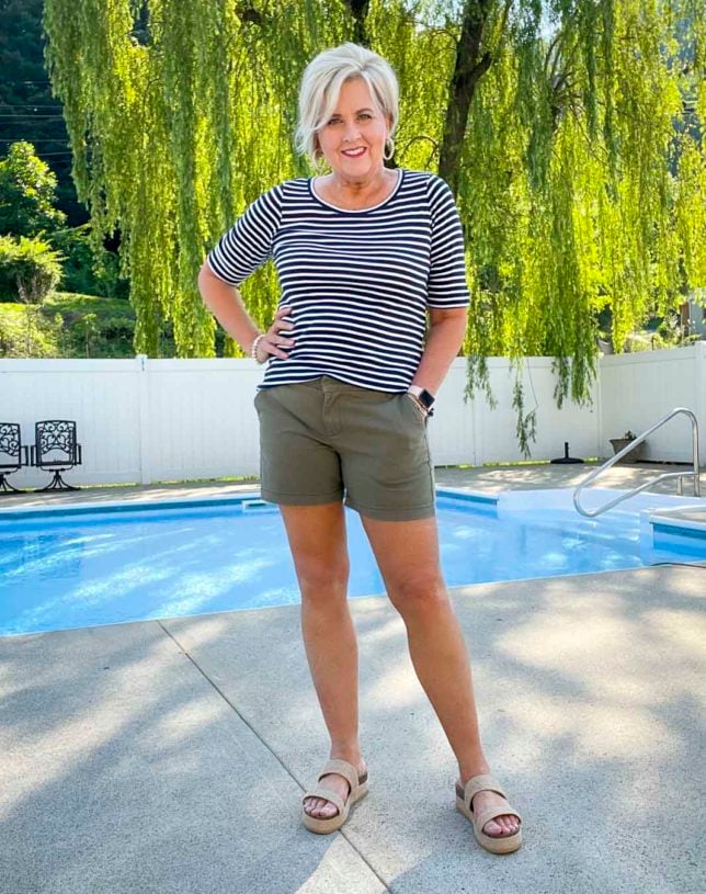 Fashion Blogger 50 Is Not Old is wearing a casual style striped navy and white t-shirt and olive twill shorts with platform sandals