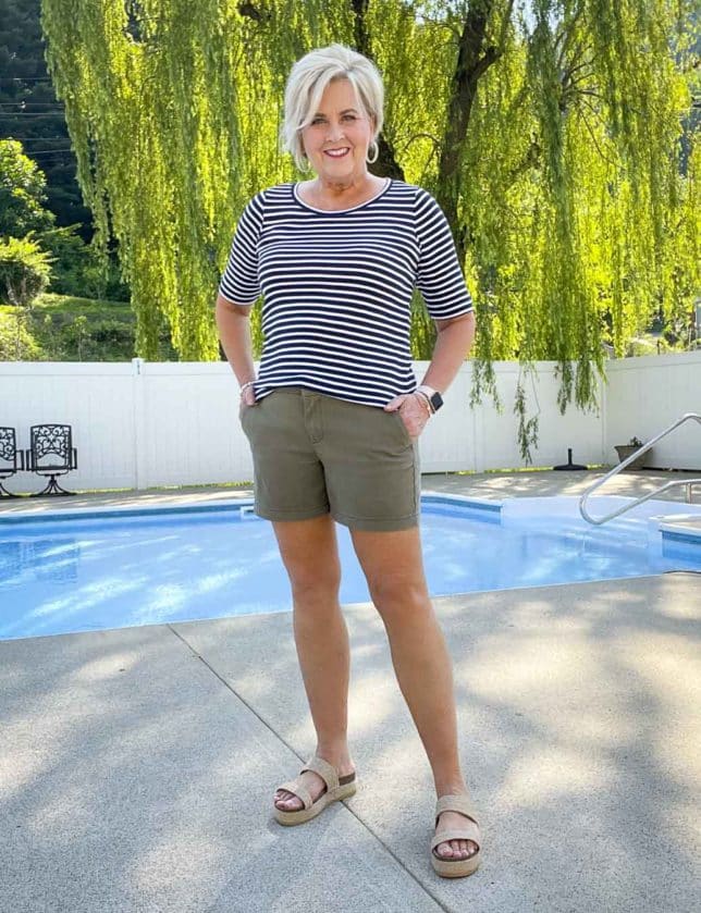 Fashion Blogger 50 Is Not Old is wearing a casual style striped navy and white t-shirt and olive shorts with platform sandals