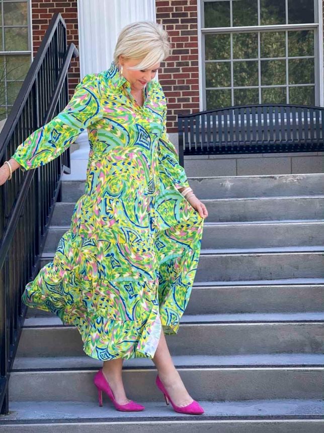 Fashion Blogger 50 Is Not Old is ready for an indoor wedding in this colorful tropical midi shirt dress with bright pink suede heels