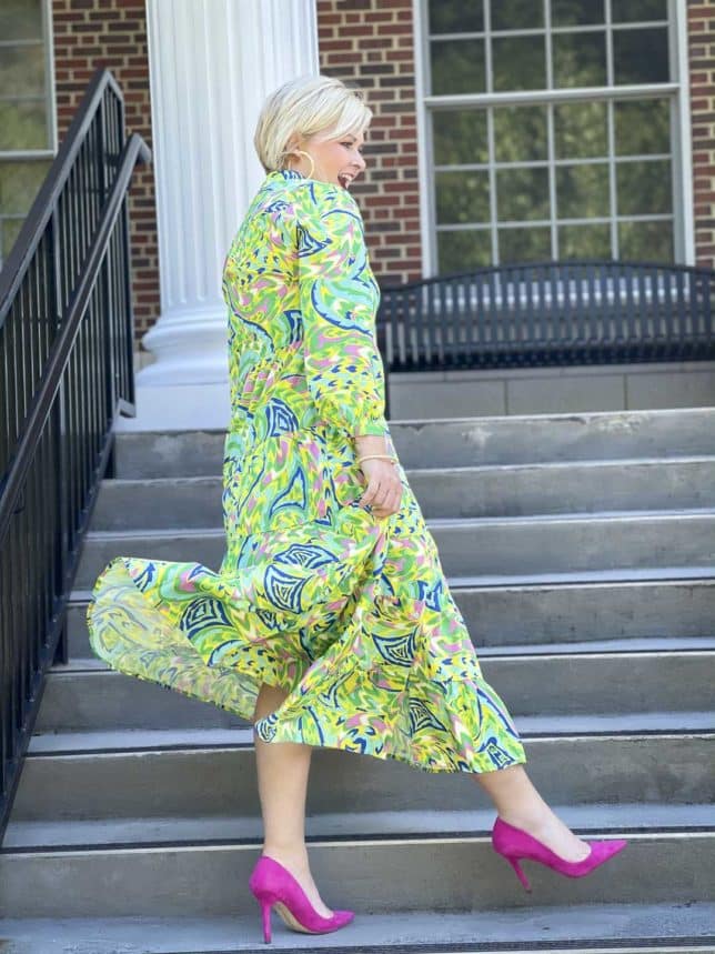 Fashion Blogger 50 Is Not Old is ready for an indoor wedding in this tropical midi shirt dress with bright pink suede pumps