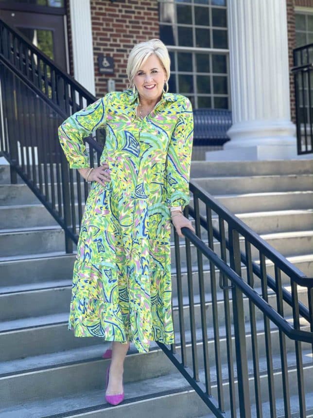 Fashion Blogger 50 Is Not Old is ready for an indoor wedding in this colorful tropical midi shirt dress with bright pink suede pumps