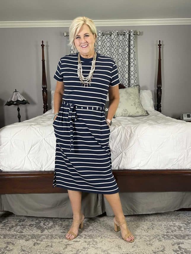 Fashion Blogger 50 Is Not Old is wearing a belted navy and white striped dress with cork heels for a mini try on session with Walmart