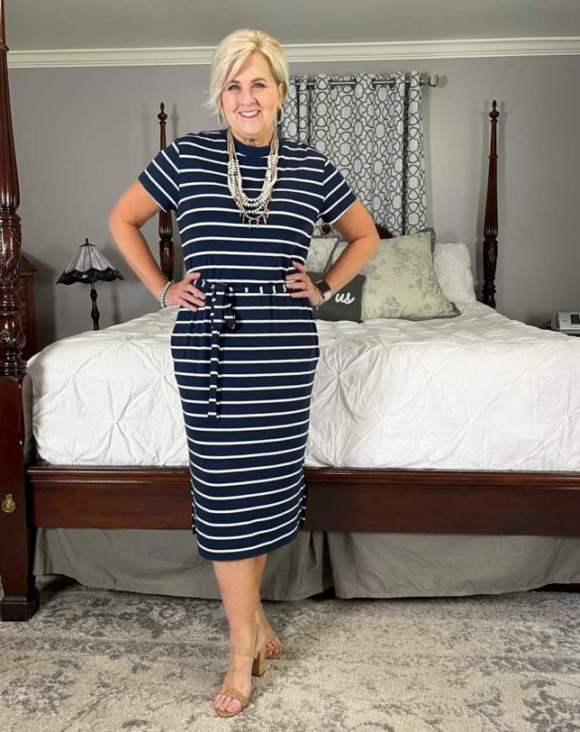 Fashion Blogger 50 Is Not Old is wearing a navy and white striped dress with cork heels for a mini try on session with Walmart