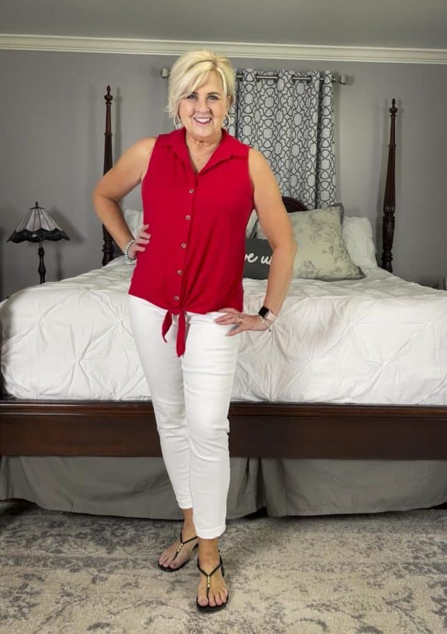 Fashion Blogger 50 Is Not Old is wearing a red knot tie sleeveless top with white jeans and black sandals for a mini try on session with Walmart