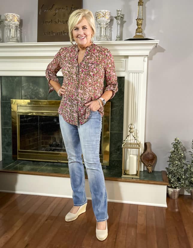 Fashion Blogger 50 Is Not Old is wearing a floral button-up blouse with bootcut jeans and neutral wedge espadrilles