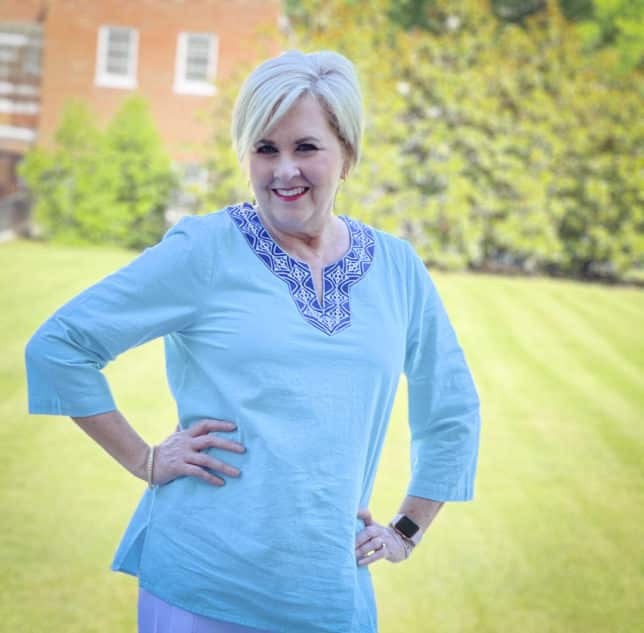 Fashion Blogger 50 Is Not Old is wearing a beautiful aqua tunic with a patterned neckline 