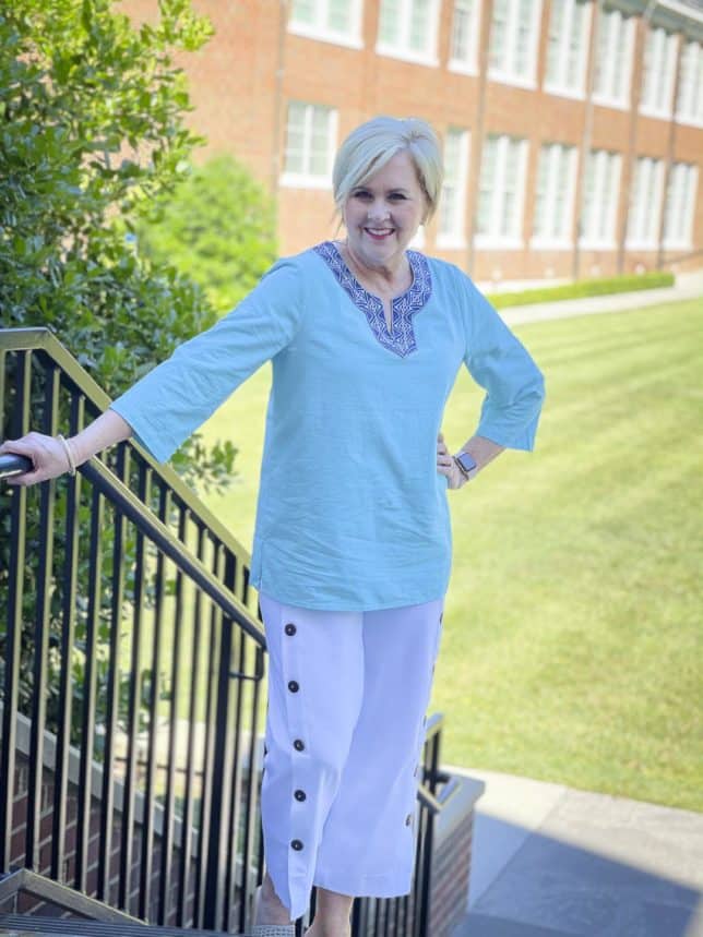 Fashion Blogger 50 Is Not Old is wearing a beautiful aqua blue tunic with a patterned neckline