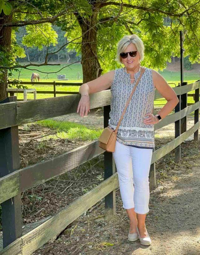 Fashion Blogger 50 Is Not Old is wearing white crop fringe jeans with a elephant print top with pockets