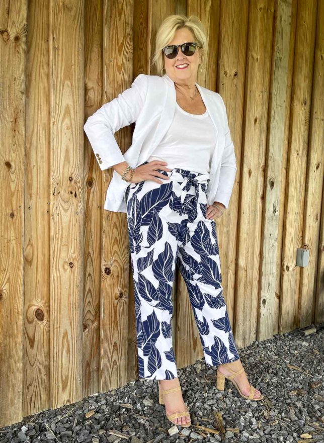 Fashion Blogger 50 Is Not Old is looking cool and crisp in a white on white chic look with navy and white palm print ankle pants
