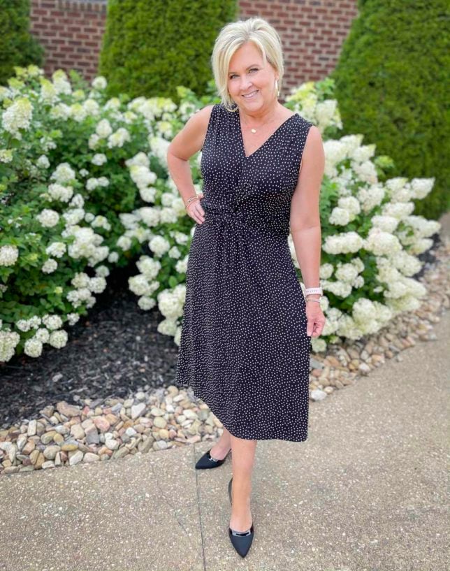 Fashion Blogger 50 Is Not Old is looking chic in this twist front black and white dotted dress with black heels from Kohl's