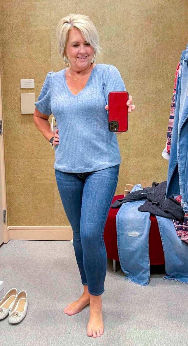 Fashion Blogger 50 Is Not Old is wearing a blue v-neck sweater with skinny jeans from the Nordstrom Anniversary Sale