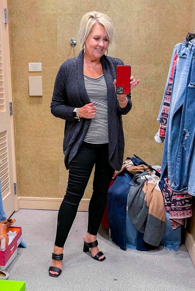 Fashion Blogger 50 Is Not Old is wearing a charcoal circle cardigan, a black and white tee, and black skinny jeans and black heels from the Nordstrom Anniversary Sale