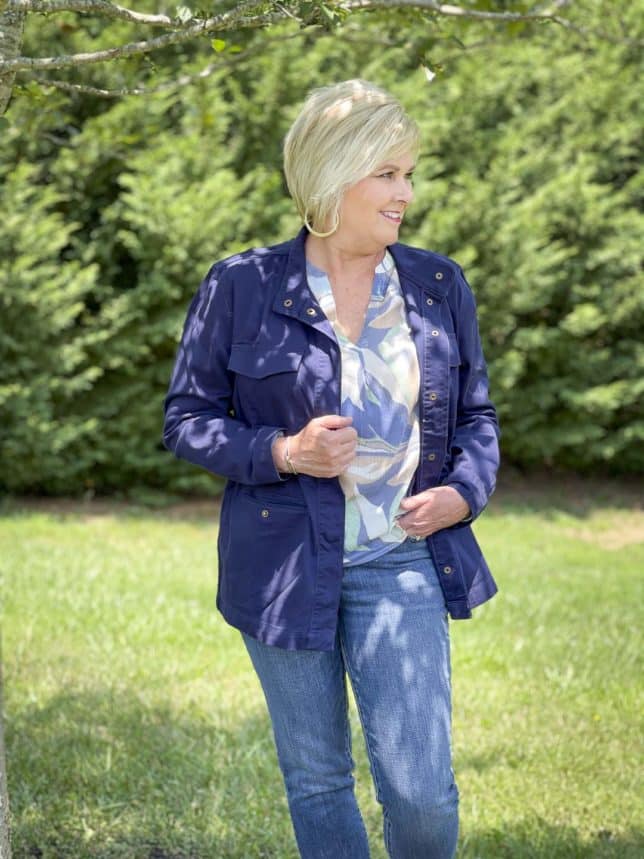 Fashion Blogger 50 Is Not Old is wearing a v-neck long sleeve top with a navy utility jacket and jeans