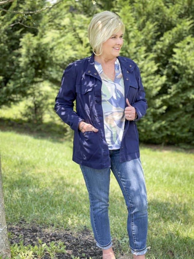 Fashion Blogger 50 Is Not Old is wearing a v-neck long sleeve top with jeans, and a navy utility jacket