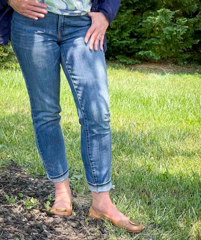 Fashion Blogger 50 Is Not Old is wearing cuffed jeans and flats by Tory Burch