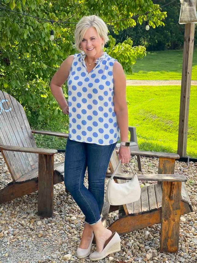 Fashion Blogger 50 Is Not Old is wearing a white and blue polka dot top with skinny jeans and espadrille shoes
