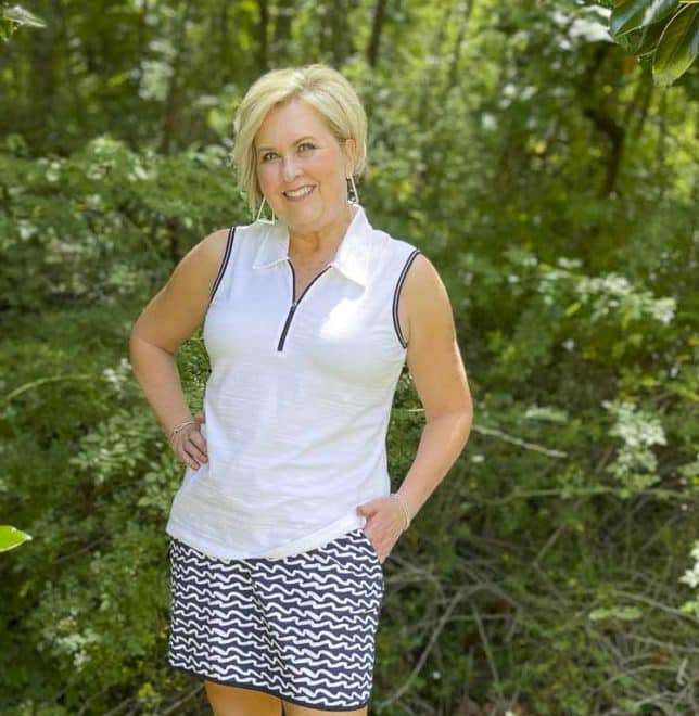 Fashion Blogger 50 Is Not Old is wearing a navy and white wave skort with a white quarter zip top