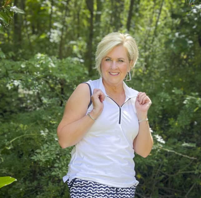 Fashion Blogger 50 Is Not Old is wearing a white quarter zip top with navy trim