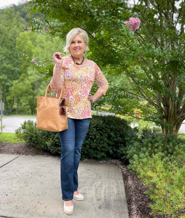 Fashion Blogger 50 Is Not Old is styling a bright colored animal print top and jeans now and later for fall