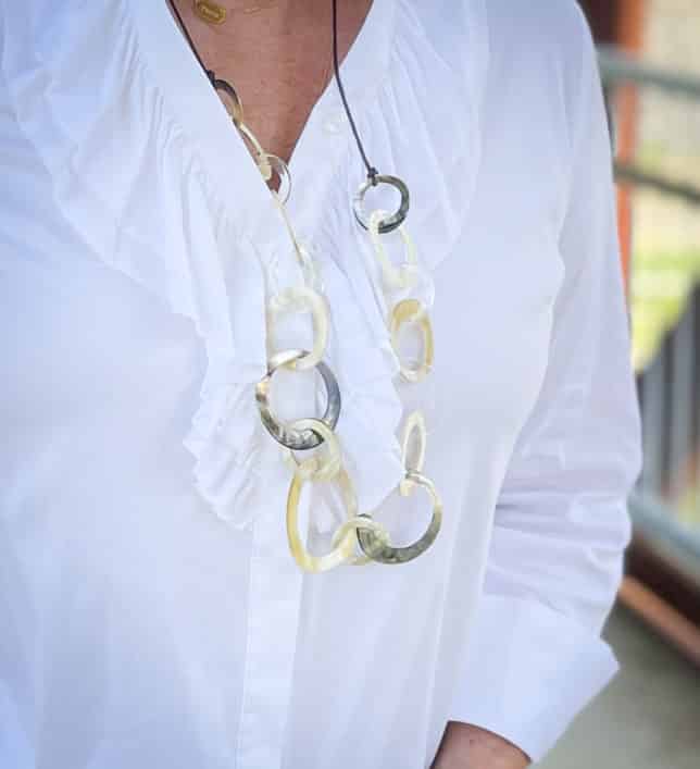 Over 40 Fashion Blogger, Tania Stephens, is wearing a long shell necklace