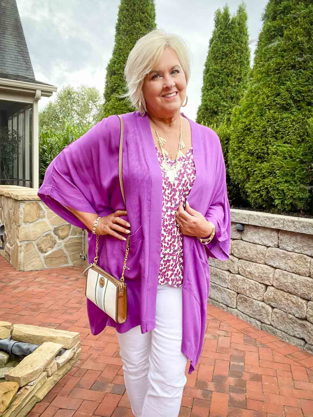 Over 40 fashion blogger, Tania Stephens is wearing a purple cardigan with white jeans