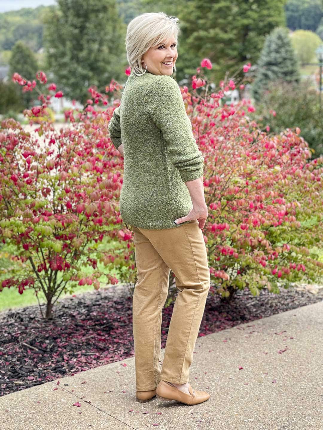 Over 40 Fashion Blogger, Tania Stephens is showing the back of a warm and cozy fall outfit of an olive green sweater and camel corduroy pants