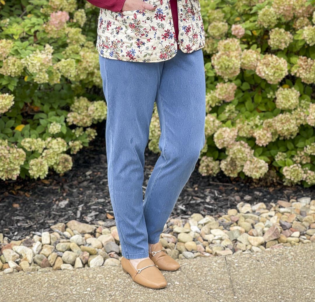 Over 40 fashion blogger, Tania Stephens, is wearing knit jeans with camel loafers