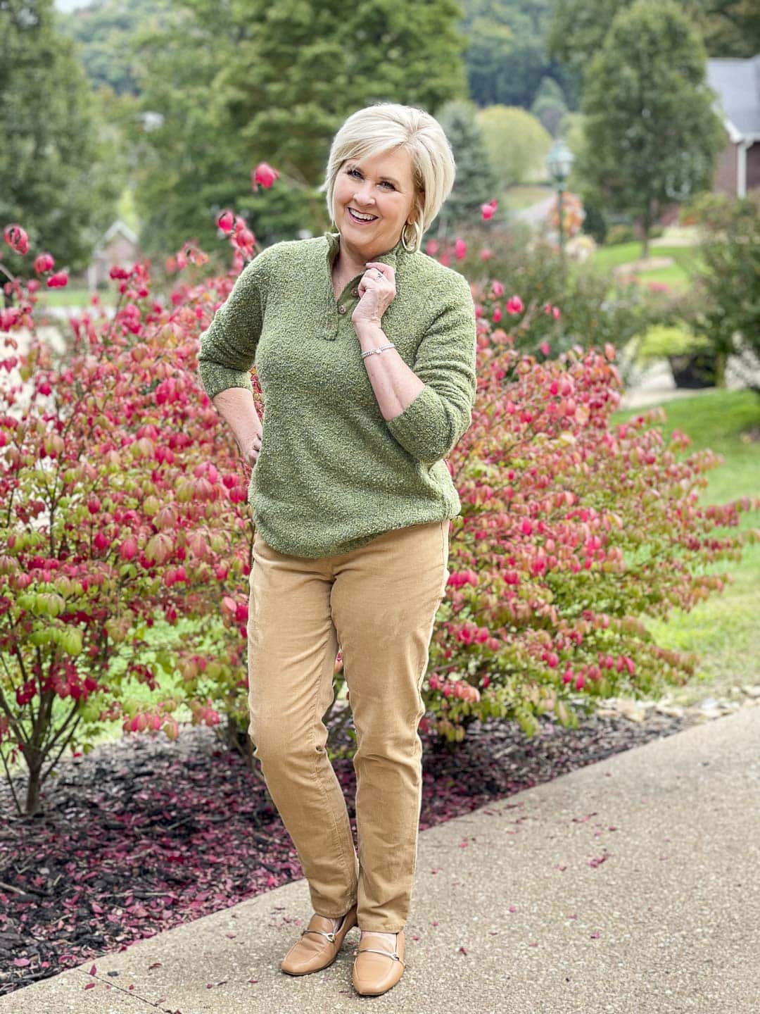 Over 40 Fashion Blogger, Tania Stephens is wearing a warm and cozy fall outfit of an olive sweater and corduroy pants