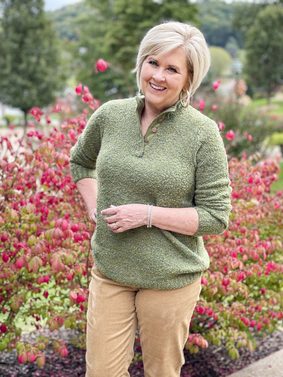 Over 40 Fashion Blogger, Tania Stephens is wearing a warm and cozy fall outfit of an olive green button sweater