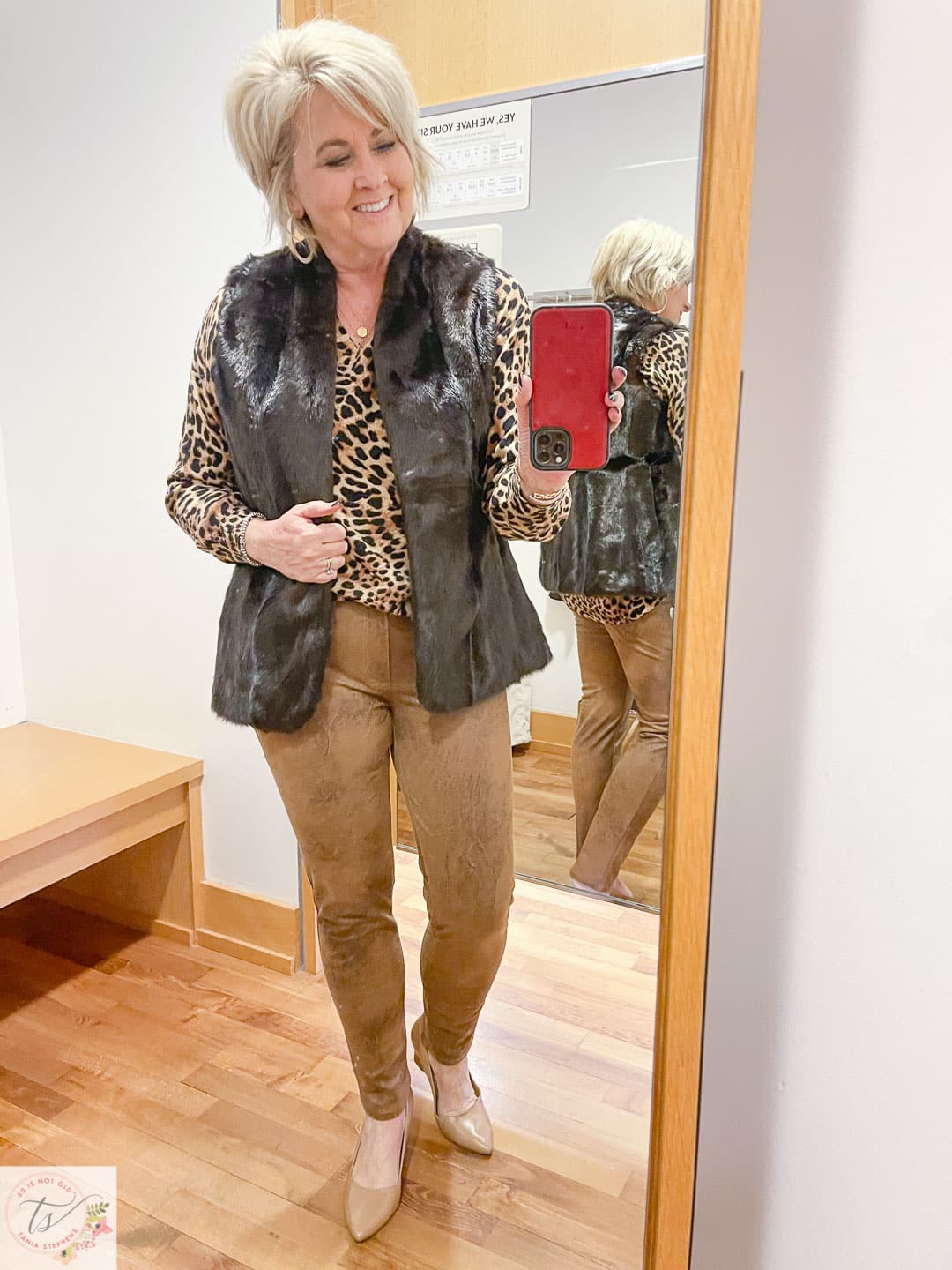 Over 40 Fashion Blogger, Tania Stephens, is trying on a Chico's animal print tunic, a faux fur vest, and faux suede ankle pants