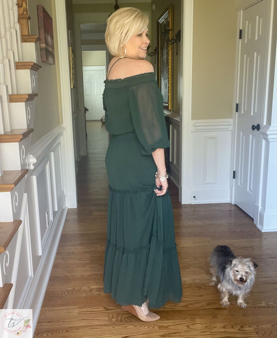 Over 40 Fashion Blogger, Tania Stephens is wearing an off the shoulder halter deep green tiered maxi dress