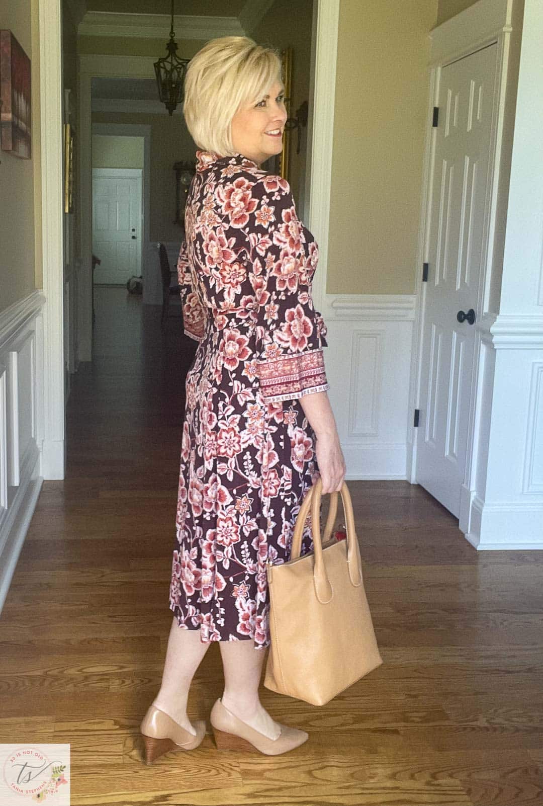 Over 40 Fashion Blogger, Tania Stephens is ready for a fall wedding wearing this muted floral print midi dress and nude wedge shoes