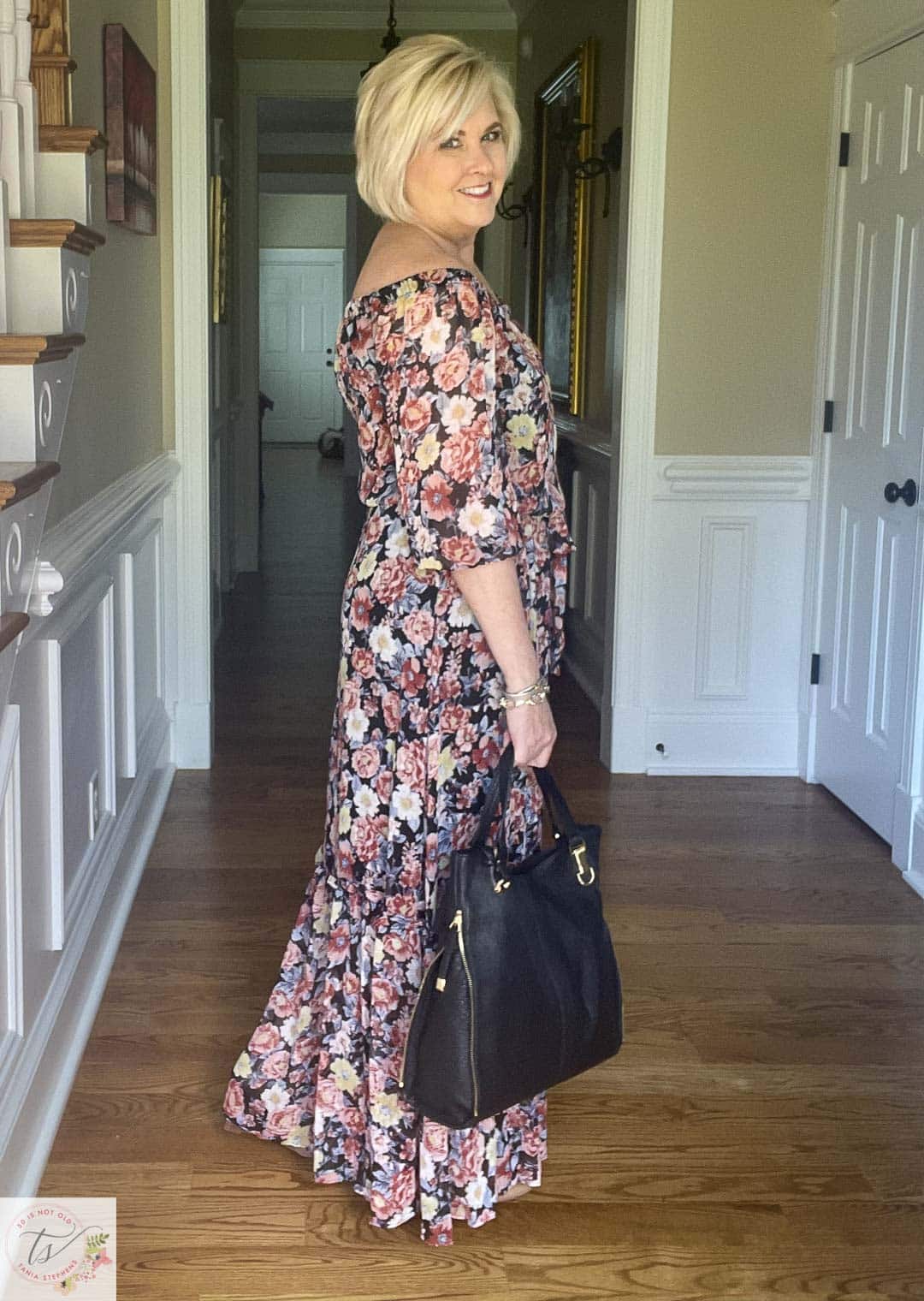 Over 40 Fashion Blogger, Tania Stephens is ready for a fall wedding wearing this off the shoulder floral print maxi dress and gold jewelry