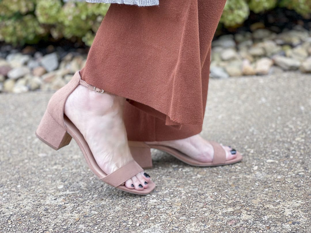 Over 40 fashion blogger, Tania Stephens, is wearing a rust sweater pants and neutral heels