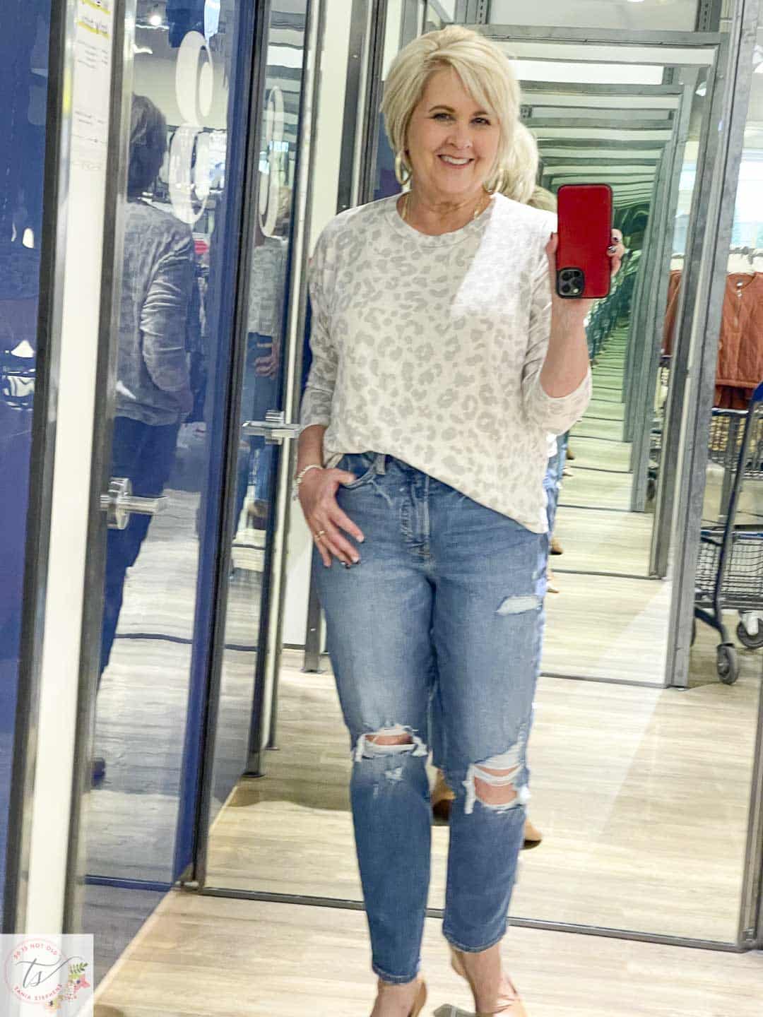 Over 40 Fashion Blogger, Tania Stephens, is doing a try on at Old Navy wearing a leopard print long sleeve tee with ripped straight leg jeans