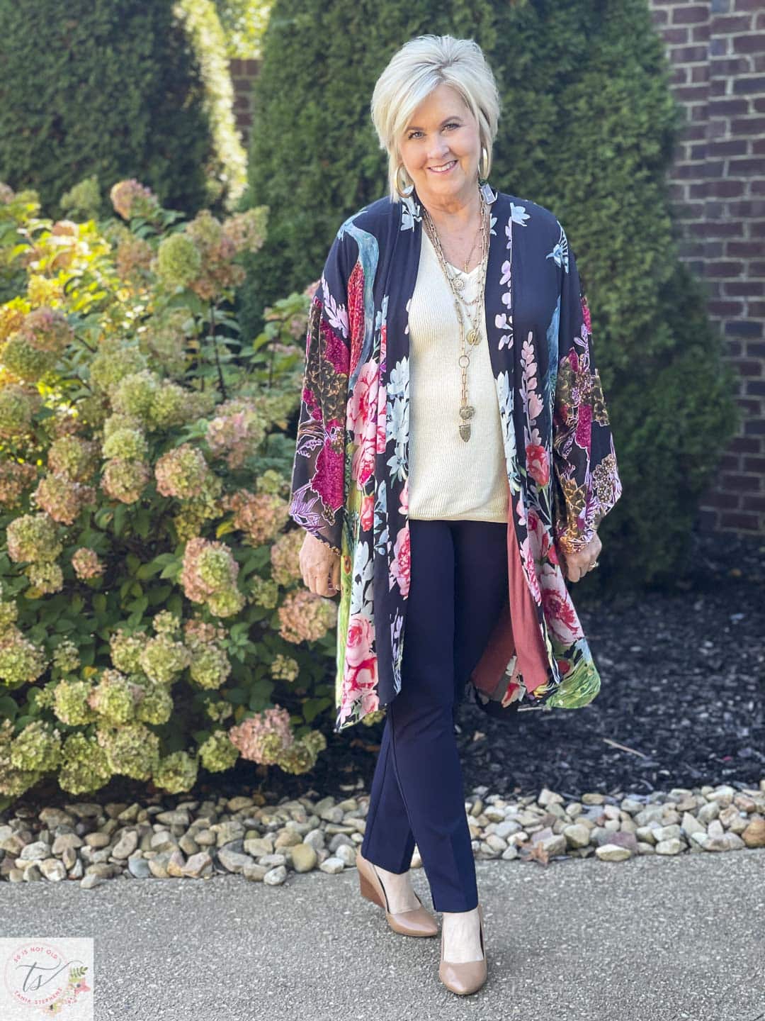 Over 40 Fashion Blogger, Tania Stephens is wearing a statement making Ruana with navy pants from Chico's