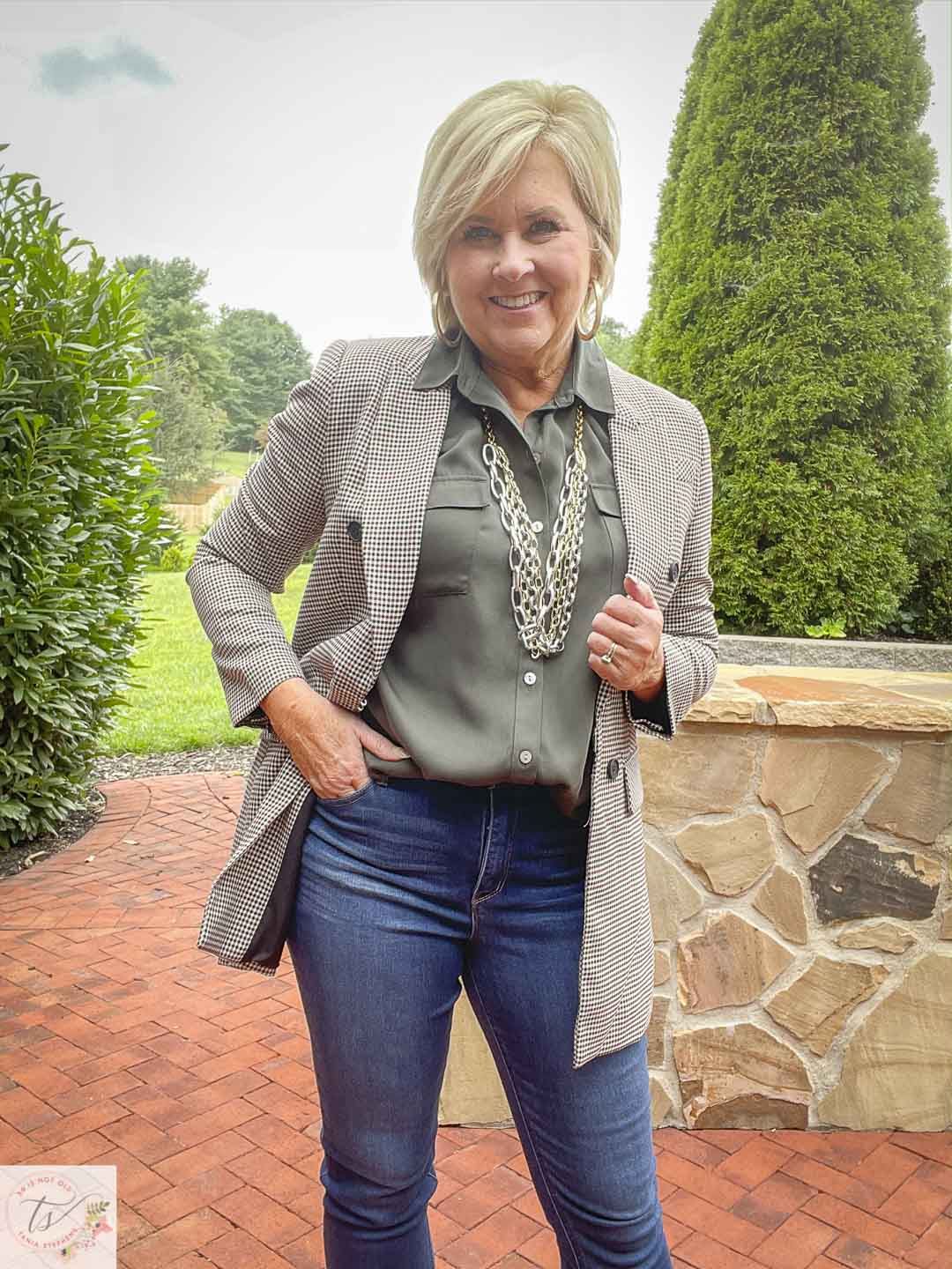 Over 40 Fashion Blogger, Tania Stephens, is wearing a plaid double breasted blazer with an olive button-up shirt