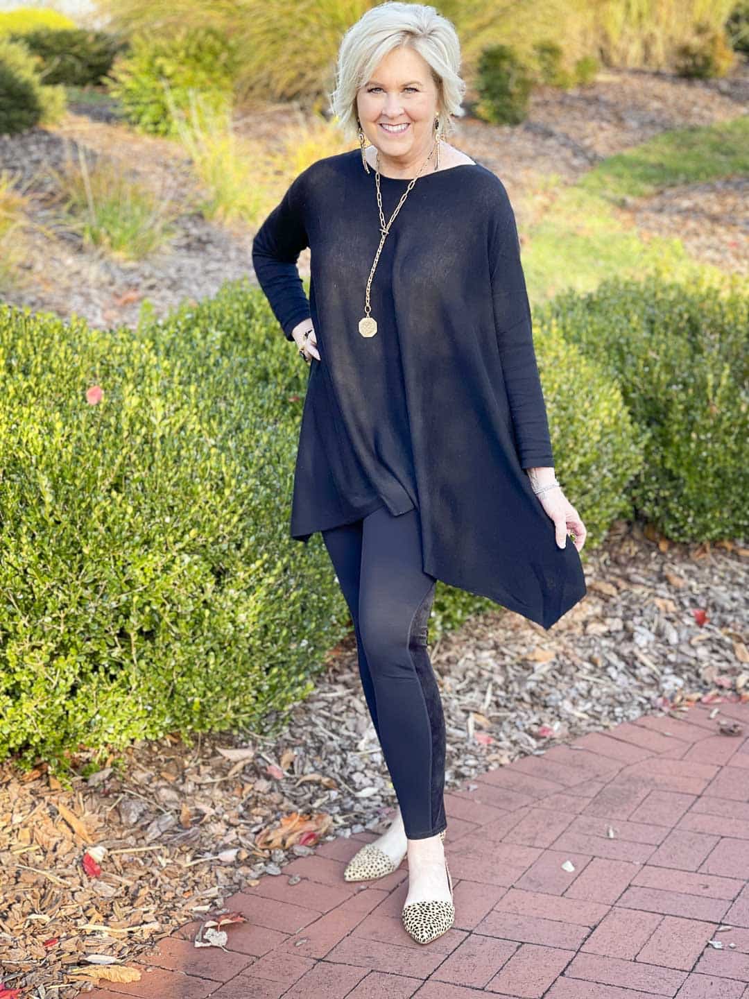 Over 40 Fashion Blogger, Tania Stephens is wearing a black on black outfit with gold jewelry and leopard print flats