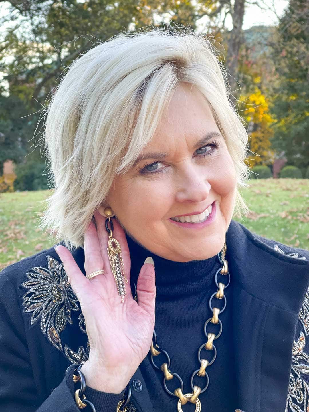 Over 40 Fashion Blogger, Tania Stephens is wearing black and gold earrings