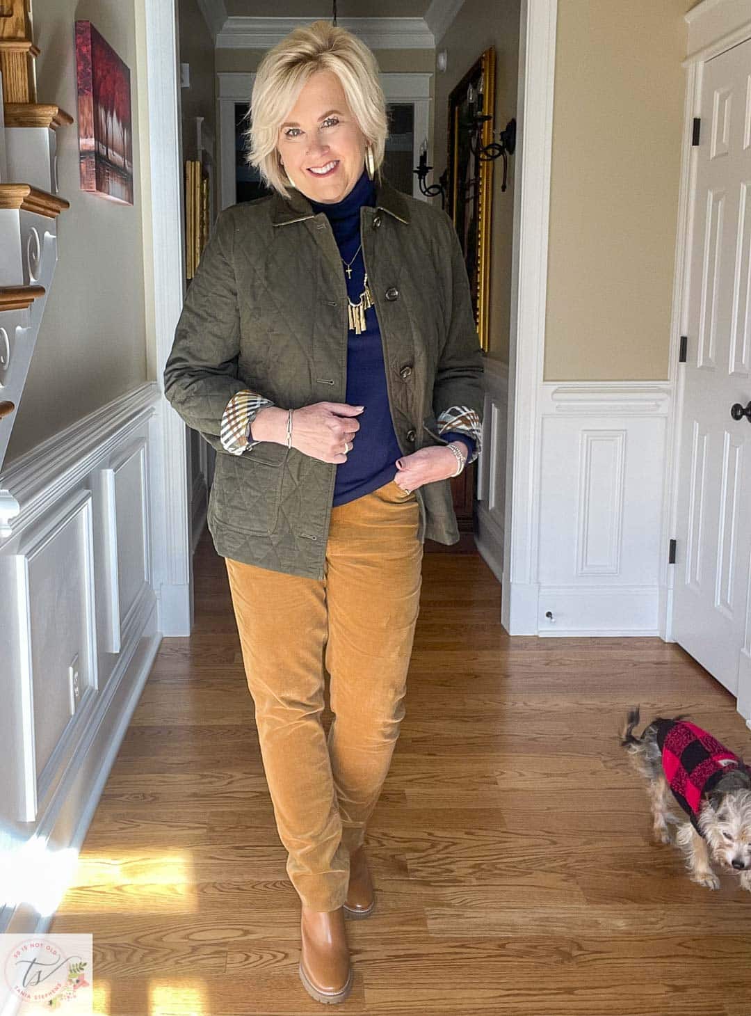 Over 40 Fashion Blogger, Tania Stephens is wearing a navy turtleneck, a quilted green jacket, and caramel corduroy pants from Talbots
