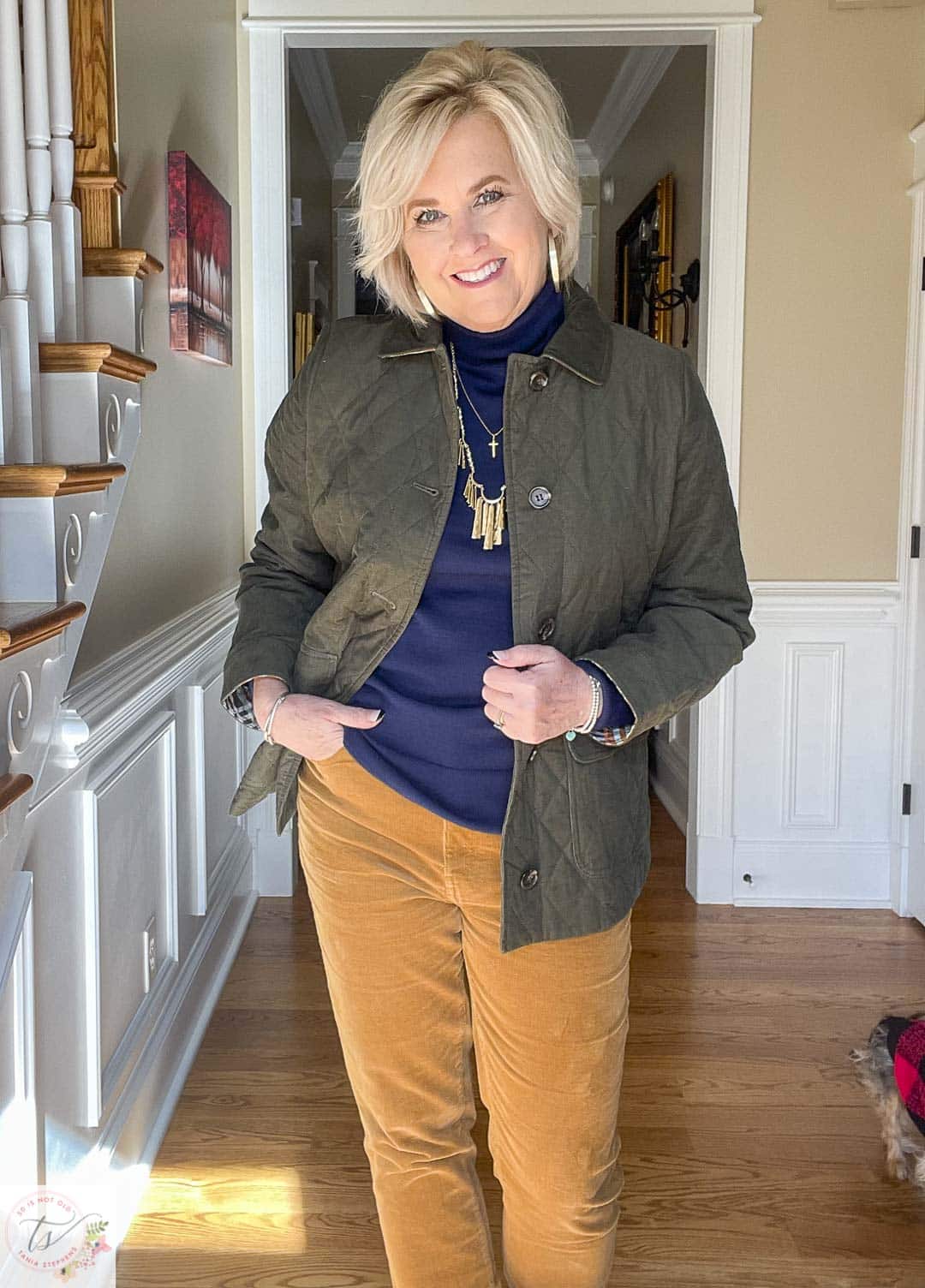 Over 40 Fashion Blogger, Tania Stephens is wearing a navy turtleneck and a green jacket from Talbots