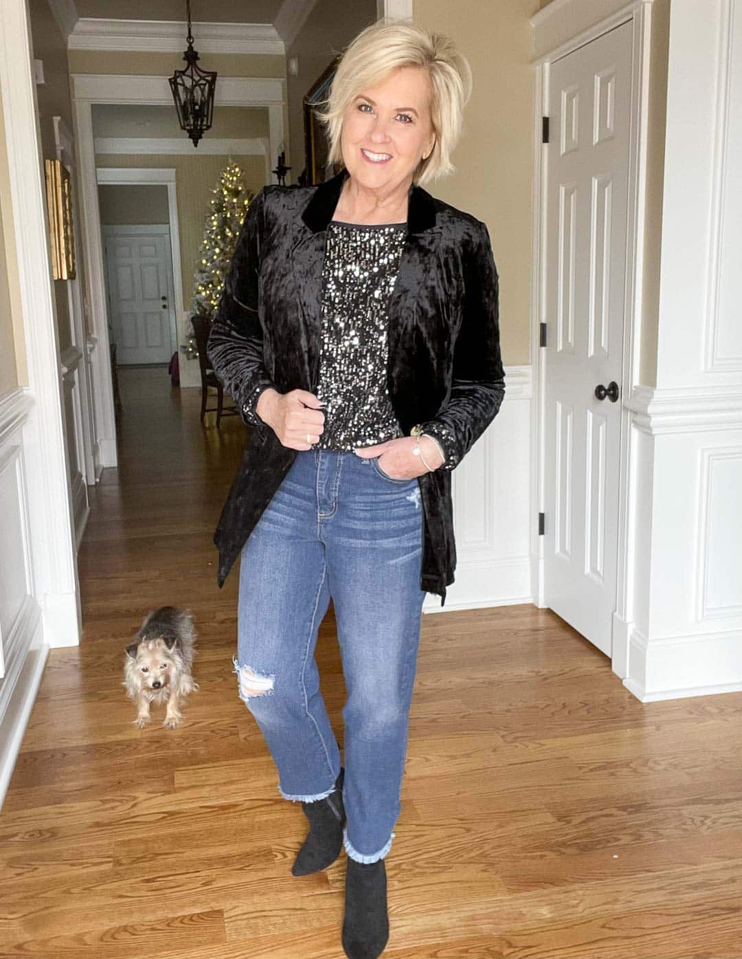 Over 40 Fashion Blogger, Tania Stephens is wearing a charcoal sequined top, distressed ankle jeans, a crushed velvet blazer, and black ankle boots