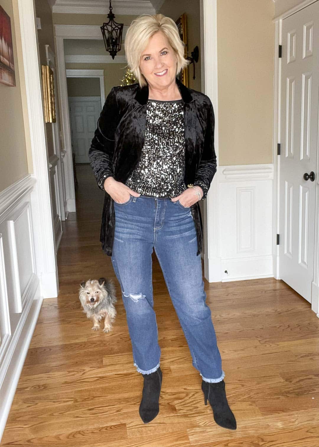 Over 40 Fashion Blogger, Tania Stephens is wearing a charcoal sequined top, distressed ankle jeans, a black crushed velvet blazer, and ankle boots