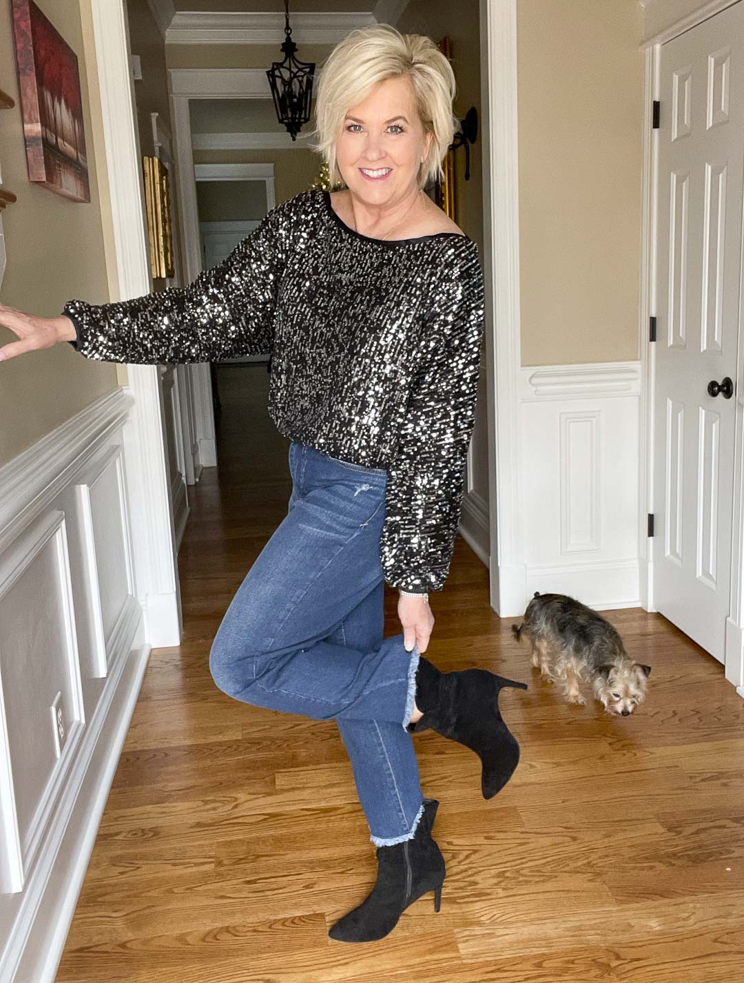 Over 40 Fashion Blogger, Tania Stephens is wearing a charcoal sequined top, ankle jeans, and black ankle boots