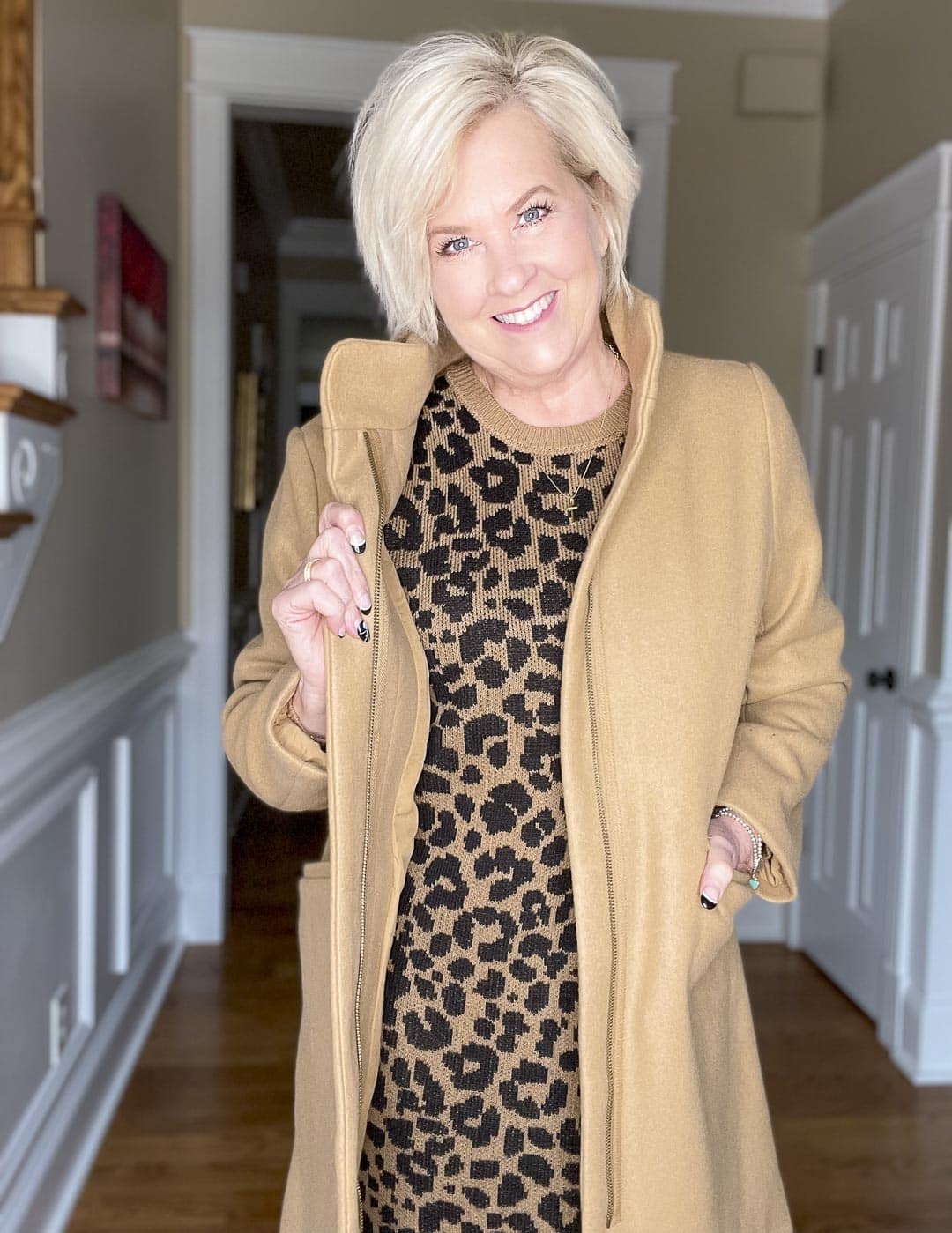 Over 40 Fashion Blogger, Tania Stephens is wearing a camel coat with a leopard print sweater dress